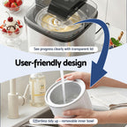 Kitchen appliance with transparent lid and removable inner bowl, shown in use.