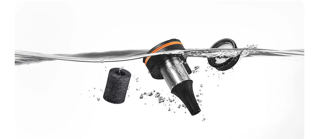 Fishing lure with a hook being submerged in water on a white background