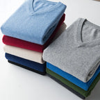 tack of folded shirts in various colors on a white background