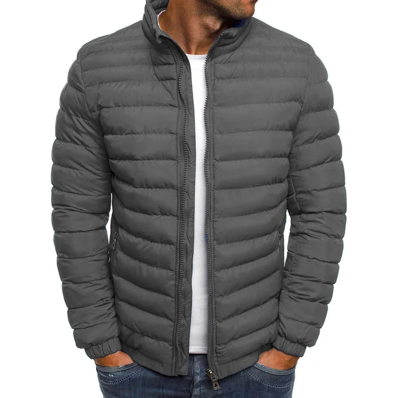 Gray puffer jacket worn by a person on a white background