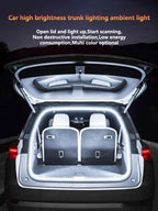 Car trunk with high brightness ambient light on, showing open lid and illuminated interior.