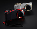 Two Xiaomi camera devices, one red and black, the other silver and gold, on a dark background.