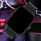 Black smartwatch on a dark background with gaming equipment
