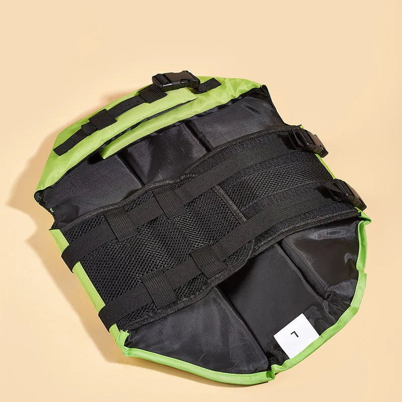 Green and black bag with multiple straps on a beige background