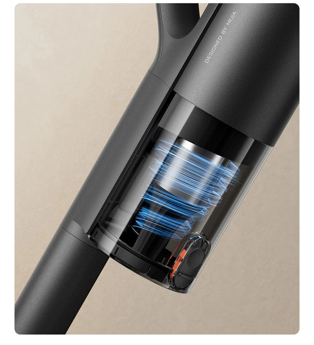 Close-up of a black handheld vacuum cleaner on a beige background