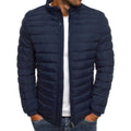 Navy puffer jacket worn by a person on a white background