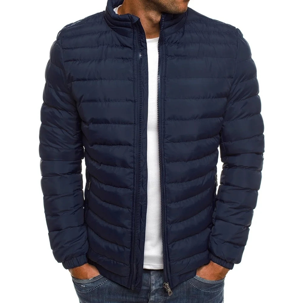 Navy puffer jacket worn by a person on a white background