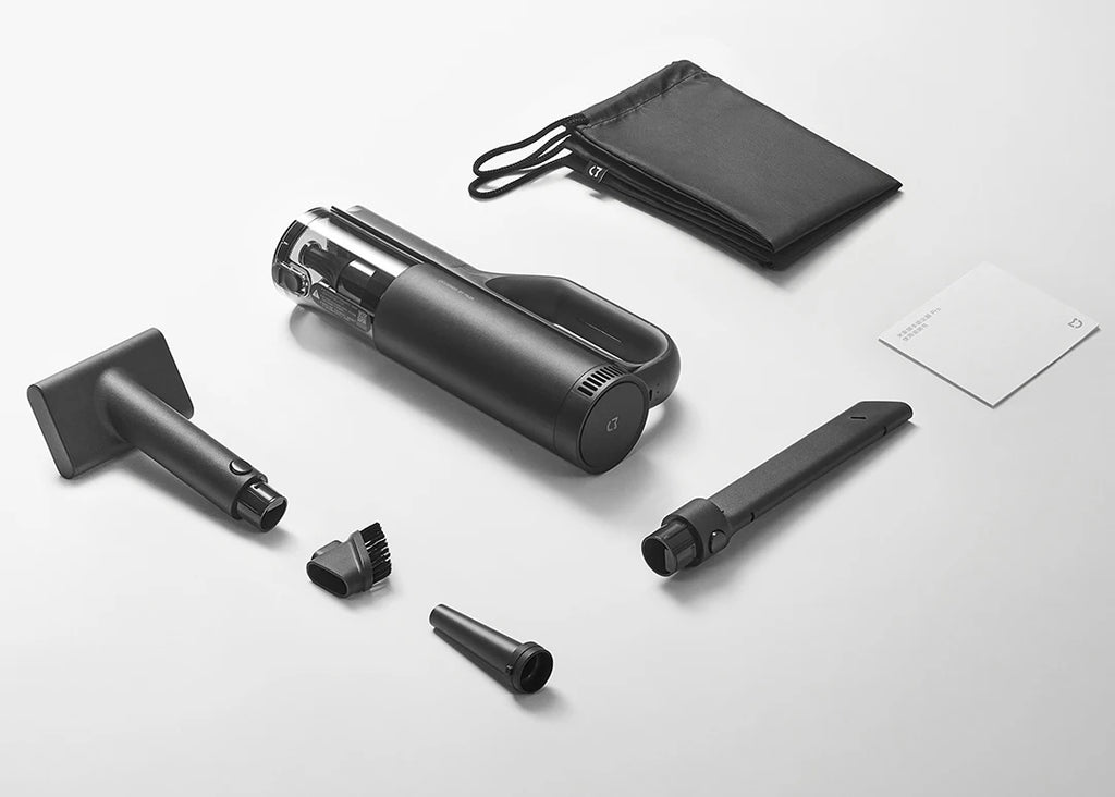 Black handheld vacuum cleaner with attachments on a white background