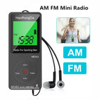 AM FM Mini Radio with earbuds on a white background