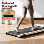 Person using a home treadmill with promotional text about cushioned running belt design.