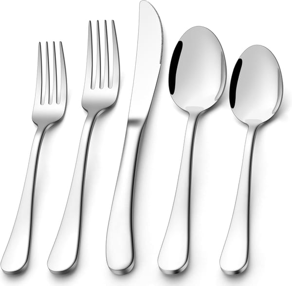 Set of silver cutlery including forks and spoons on a white background