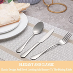 ilver cutlery set on a table with plates and a placemat.