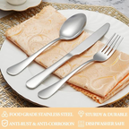 Silver cutlery set on a white plate with a decorative napkin, placed on a woven placemat.