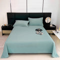 Teal bedspread on a bed with matching pillows in a modern bedroom.
