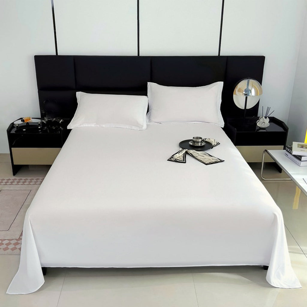 Modern bedroom with a black headboard and white bedding