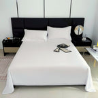 Modern bedroom with a black headboard and white bedding