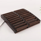 Wooden massage board with textured surface on a white background