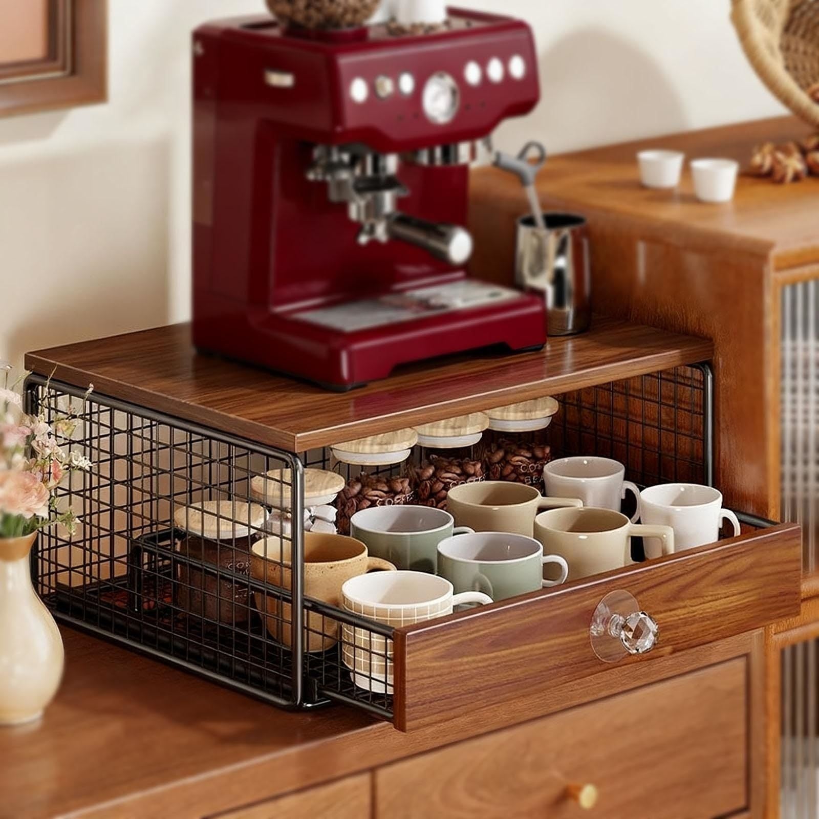 Red espresso machine with a wooden counter and cup storage drawer.