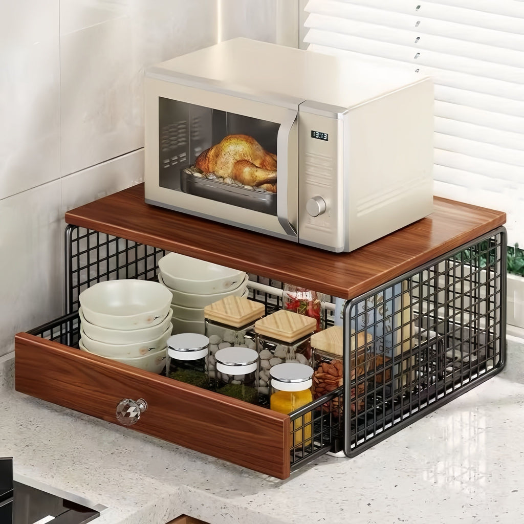Wooden kitchen counter with microwave, bowls, and a drawer organizer.