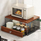 Wooden kitchen counter with microwave, bowls, and a drawer organizer.