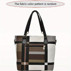 Plaid patterned handbag with black handles on a white background