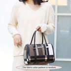 Person holding a patterned handbag with a blurred background