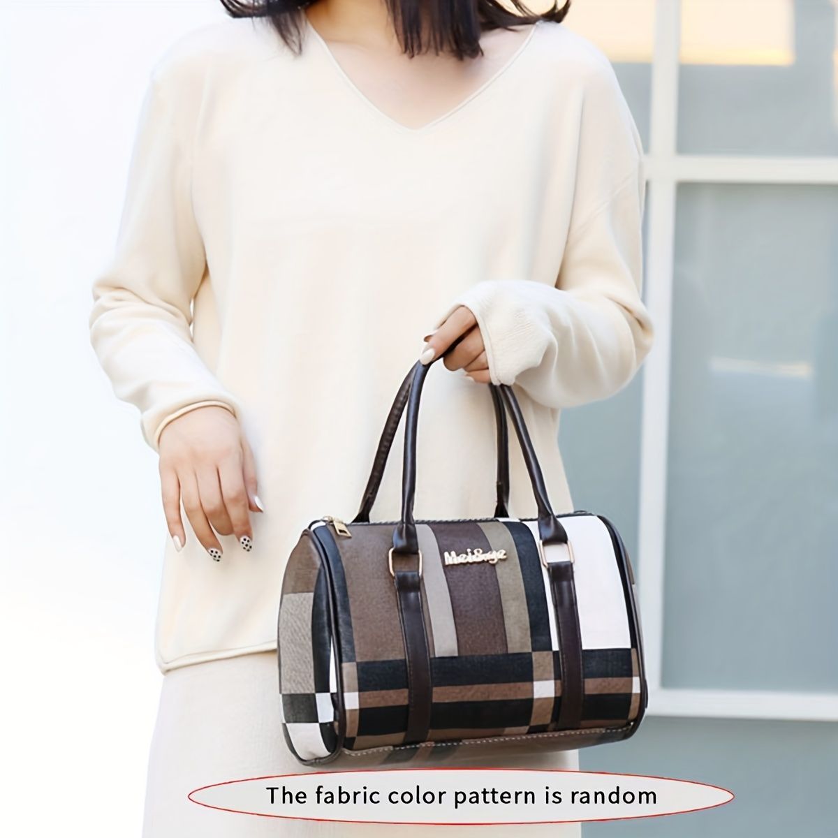 Person holding a patterned handbag with a blurred background