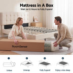 Man and woman unboxing a mattress from RoomSense in a bedroom setting.